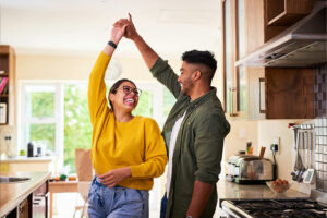 Young couple dancing together in a kitchen