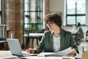 Businesswoman working on laptop at office.