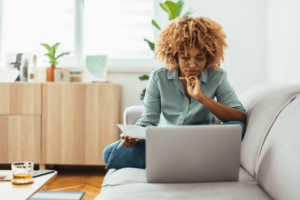 Home Office: An Afro-American Woman Looking at a Laptop.