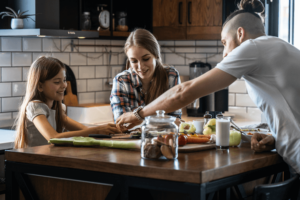 Young family preparing meal in their kitchen.